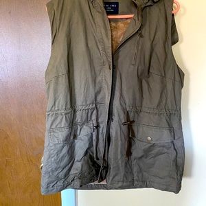 Hooded vest olive green in color fur is tan